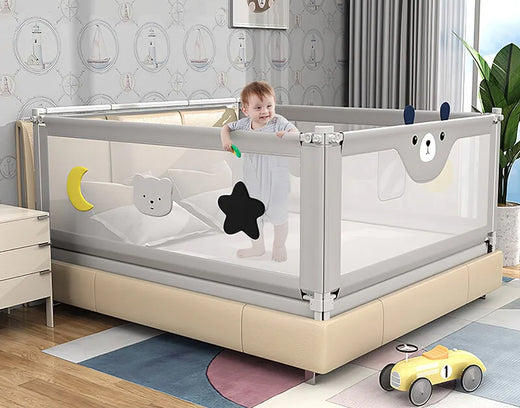 A baby playpen with soft gray mesh sides, colorful decorations, and a secure design placed on a bed.